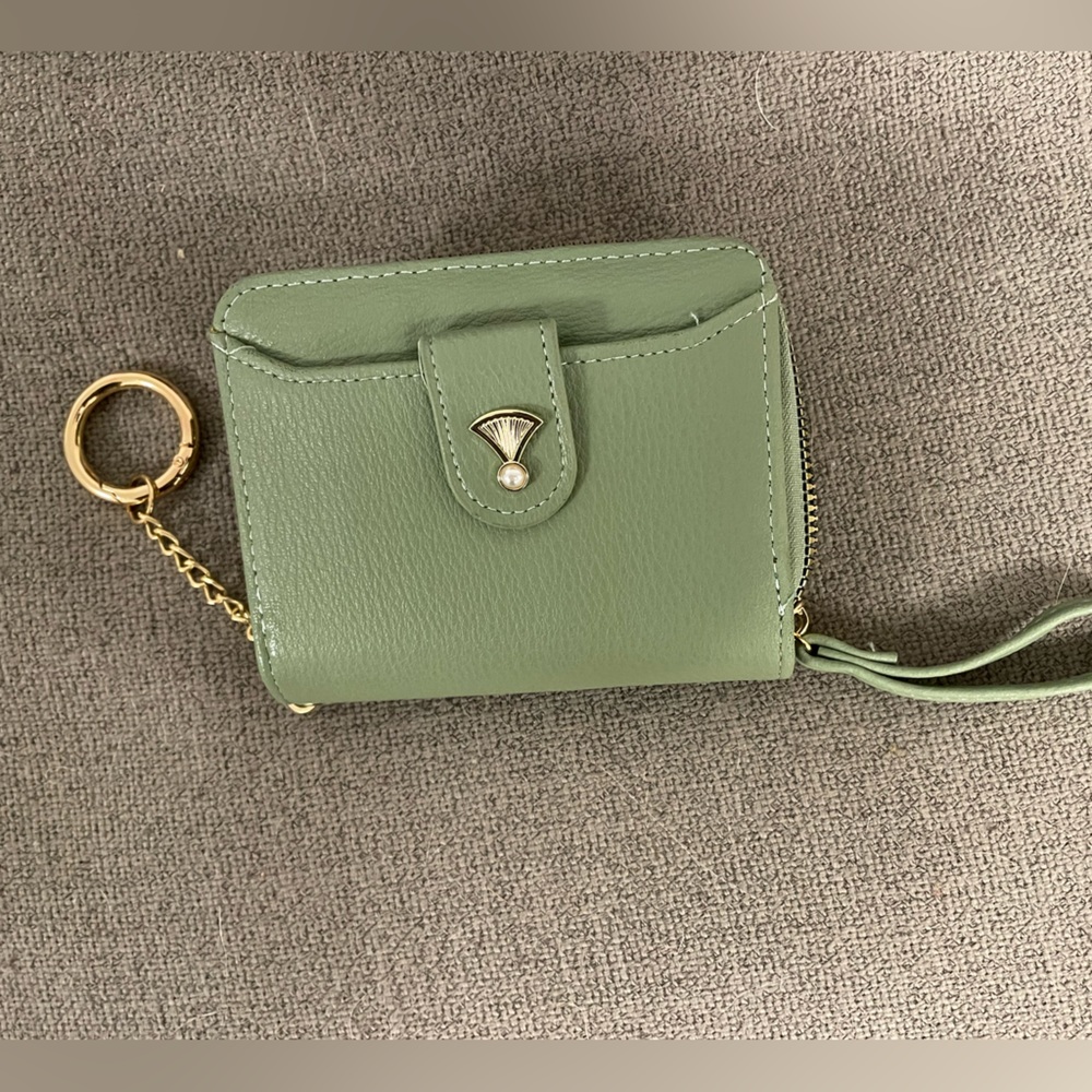 Wristlet with keychain.  Separate credit card slots and ID window.  NWT